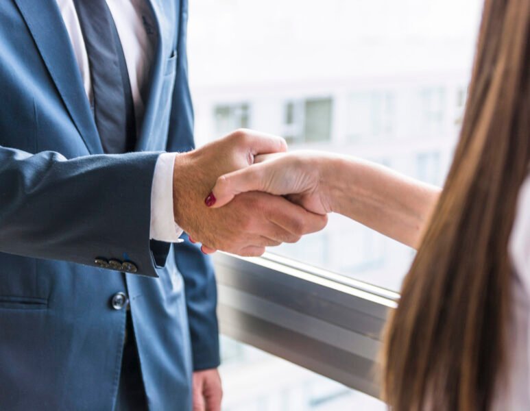 close-up-businesswoman-businessman-shaking-hands