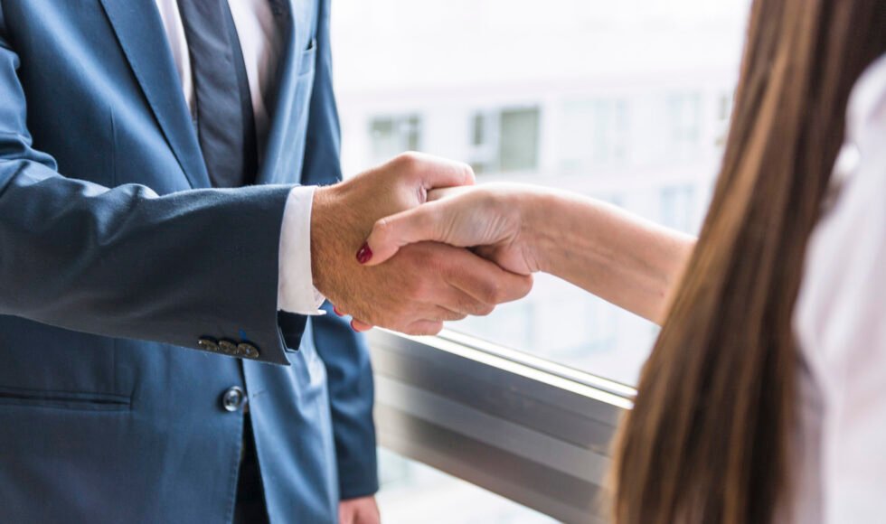 close-up-businesswoman-businessman-shaking-hands